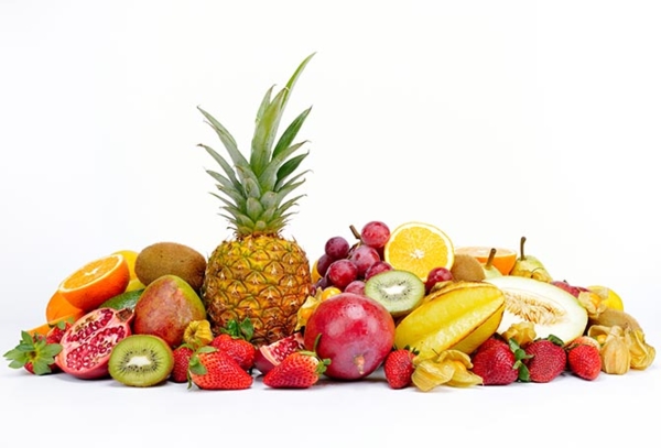 a photo of a fruit pile like pineapple, watermelon, strawberries, mango, kiwi, etc.